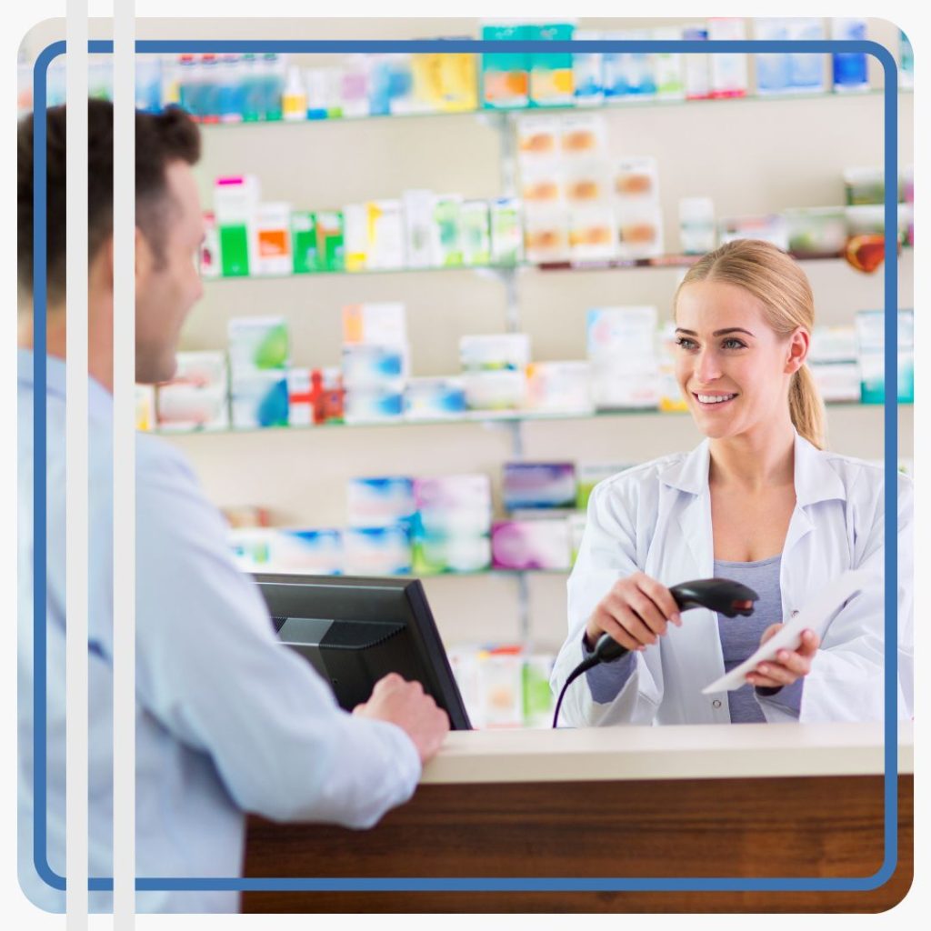 pharmacist smiling while helping patient